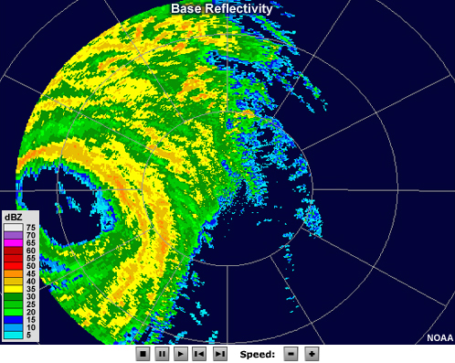 Radar reflectivity loop showing hurricane Wilma making landfall in 2005.  The eye, which is free of echo, is large and pronounced.  Bands of moderate to high reflectivity values encircle the eye, and other intense bands of precipitation can be seen spiraling outward from the storm's center.