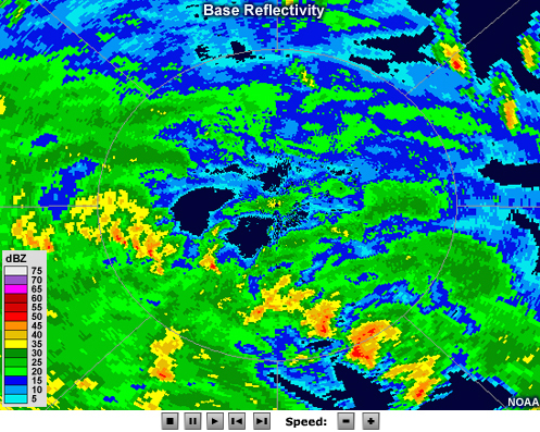 Radar reflectivity animation showing bands of intense precipitation spiraling couterclockwise about a ring of more intense precipitation with an echo-free region in its center.  Several strong, discrete cells are embedded within the northernmost rainbands.