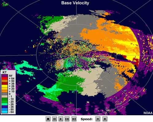 Radial velocity loop showing winds moving toward the radar on the left side of the image and away from the radar on the right.  A small area to the southwest of the radar shows an initially divergent couplet that expands in size with time.