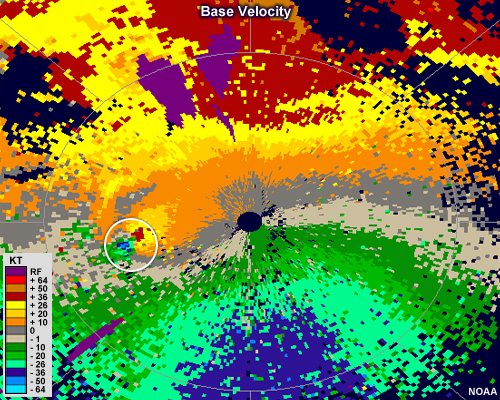 base velocity showing a small couplet of strong inbound velocities adjacent to strong outbound velocities, indicating a mesocyclone.