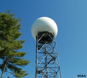 Photograph of an NWS Doppler radar tower as viewed from the ground.