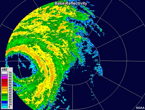 Radar reflectivity loop showing hurricane Wilma making landfall in 2005.  The eye, which is free of echo, is large and pronounced.  Bands of moderate to high reflectivity values encircle the eye, and other intense bands of precipitation can be seen spiraling outward from the storm's center.