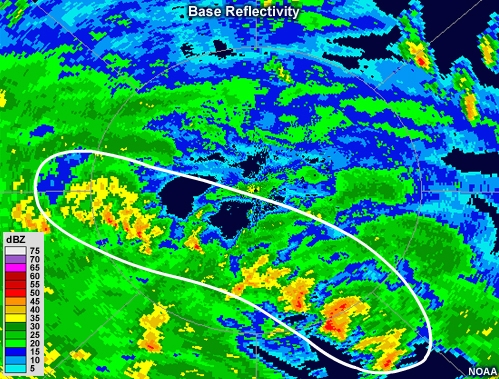 Radar reflectivity animation showing bands of intense precipitation spiraling couterclockwise about a ring of more intense precipitation with an echo-free region in its center.  Several strong, discrete cells are embedded within the northernmost rainbands.