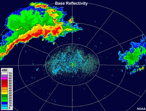 Reflectivity animation showing a large system consisting of a leading line of very intense precipitation followed by a broad area of moderate intensity precipitation.  A portion of the leading line of thunderstorms develops a bulge or bow outward toward the front over time.