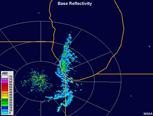 Radar reflectivity loop showing moderate intensity cells aligned in a large band that runs north to south along roughly the center of lake Michigan.